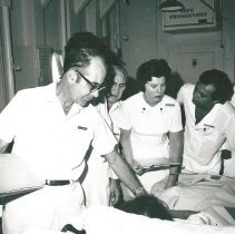 Dr Robert Wochos, Surgeon, Rotation I, with unknow nurse and medical studen